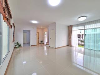 Spacious and bright living room with tiled flooring and large windows