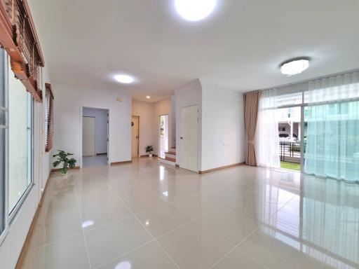 Spacious and bright living room with tiled flooring and large windows