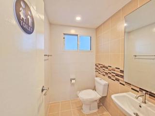 Brightly lit bathroom with beige tiling and modern fixtures