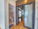 Modern bathroom with frosted glass shower doors and wooden flooring