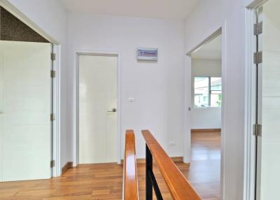Spacious hallway with wooden flooring and modern doors