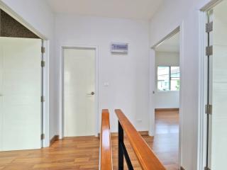 Spacious hallway with wooden flooring and modern doors