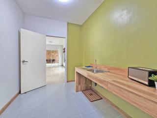 Modern kitchen with wooden countertops and light green walls