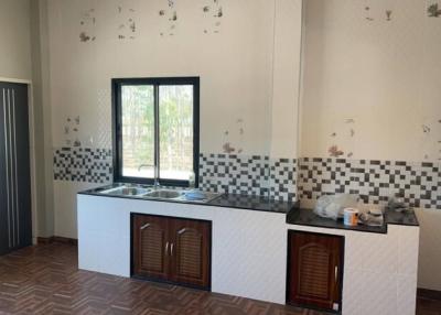 Spacious kitchen with large window and patterned backsplash