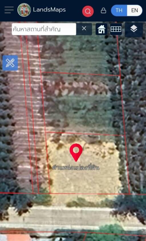 Blurry aerial view of a plot of land with location marker