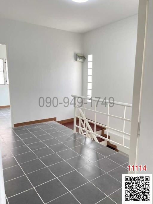 Empty room with grey tiled floor and white walls