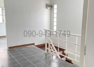 Empty room with grey tiled floor and white walls