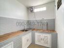 Modern kitchen with wooden countertops and white cabinetry