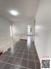 Spacious hallway with tile flooring and natural light