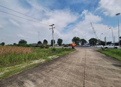 Spacious open outdoor area near a road under a clear blue sky