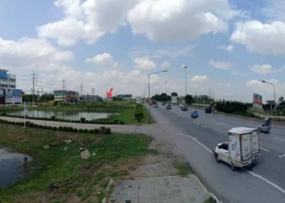 Panoramic view of a busy street with nearby buildings under a cloudy sky