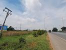 View of a roadside with clear sky and sparse traffic