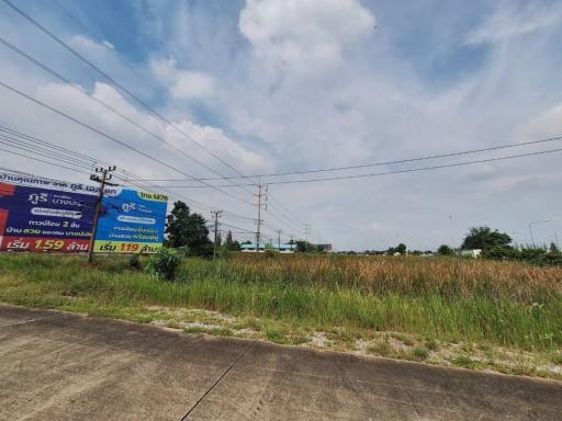 Vacant land with for-sale signs under a clear blue sky