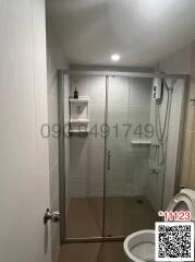 Modern bathroom interior with glass shower and white tiles