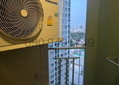 Compact utility area with city view and Panasonic air conditioning units