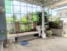 Spacious patio area with large windows and greenery