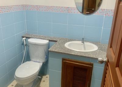 Compact bathroom with tiled walls and modern fixtures