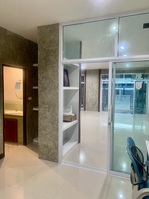Modern home interior with glass door entrance and tiled flooring