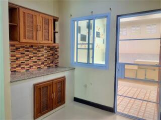 Spacious kitchen with wooden cabinets and ample natural light