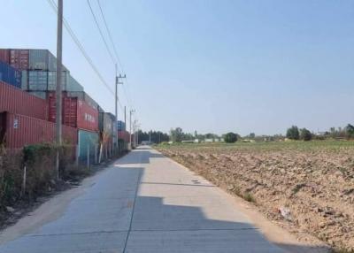 Rural road with shipping containers and agricultural land