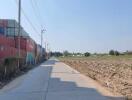 Rural road with shipping containers and agricultural land