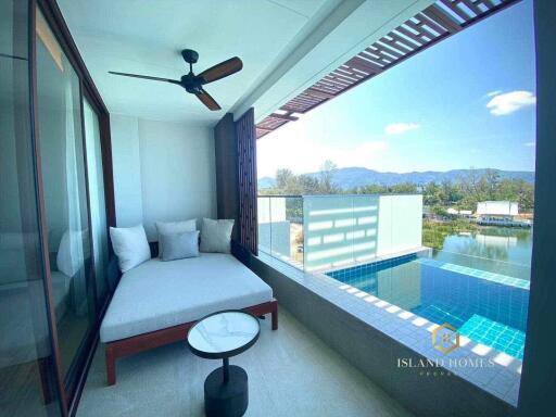 Modern bedroom with a pool view and outdoor lounge space