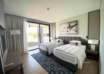 Spacious bedroom with two beds and balcony access