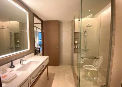 Elegant modern bathroom with glass shower, large mirror and high-end fixtures