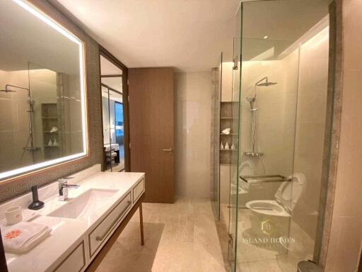 Elegant modern bathroom with glass shower, large mirror and high-end fixtures