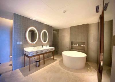 Modern spacious bathroom with double vanity and freestanding tub