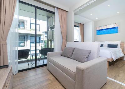 Bright and modern bedroom with an open layout connecting to a balcony