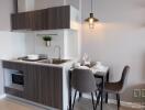 Modern kitchen with clean design, equipped with built-in appliances, and a dining area