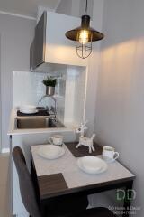 Modern kitchen with dining area and stylish lighting