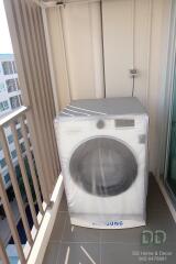 Compact balcony with a washing machine and view of apartment buildings