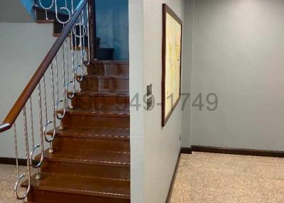 Modern wooden staircase with metal balusters in a residential home