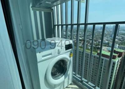 High-rise apartment balcony with a washing machine