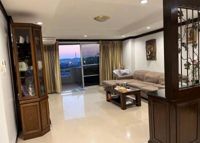 Spacious living room with city view through balcony doors