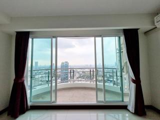 Spacious room with large windows offering a panoramic city view