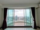 Spacious room with large windows offering a panoramic city view