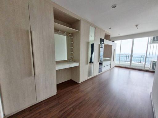 Spacious unfurnished living area with large windows and wooden flooring