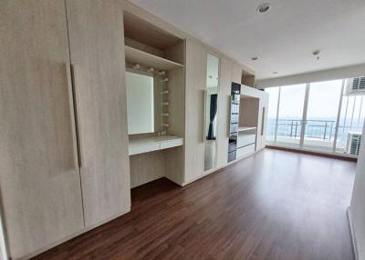 Spacious unfurnished living area with large windows and wooden flooring