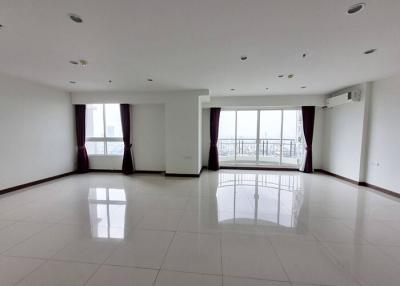 Spacious and bright empty living room with large windows and glossy tiled flooring