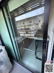 Compact balcony with glass sliding door and outdoor view