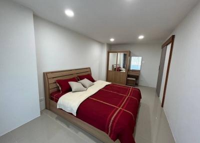 Modern bedroom with a large bed and attached bathroom
