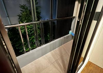 Compact balcony with safety railing at night