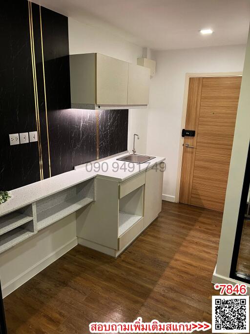 Compact modern kitchen with wooden floor and two-tone cabinets