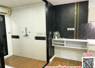 Modern entrance interior with decorative black marble wall and white storage cabinet