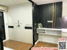 Modern entrance interior with decorative black marble wall and white storage cabinet