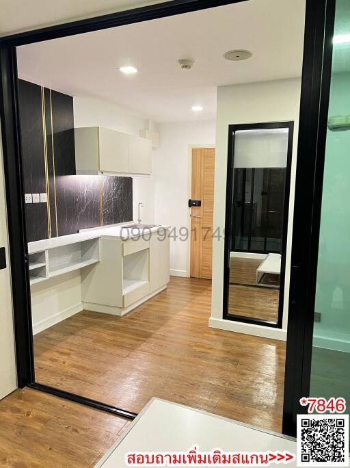 Modern kitchen with wooden floors and black framed glass doors