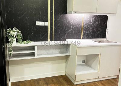 Modern kitchen with black marble walls and wooden floor